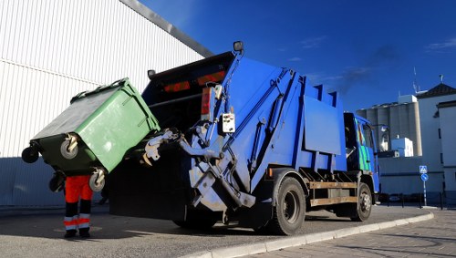 Commercial waste collection vehicle and staff preparing for collection