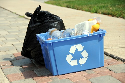 Labelled recycling bins for paper, card, glass and food waste in a commercial courtyard