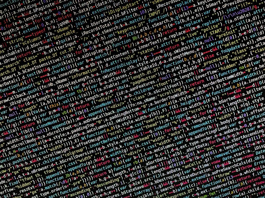 A close-up image of multicoloured computer code displayed on a screen, consisting of lines of programming syntax with various keywords, functions, and symbols in different colours such as red, green, 